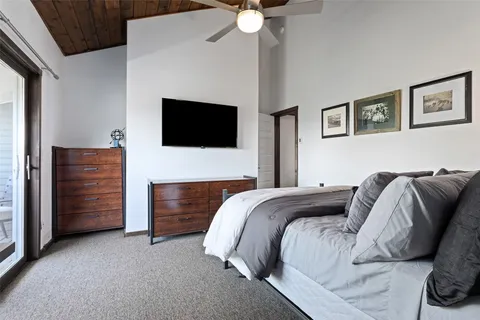 a bedroom with a bed and a television