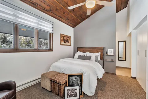 a spacious bedroom with a bed and window