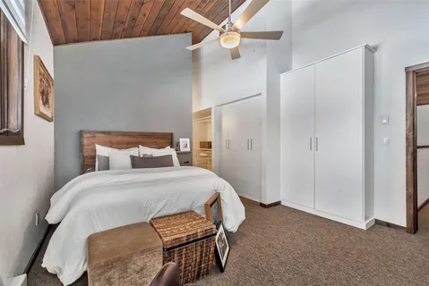 a bedroom with a bed and a chandelier