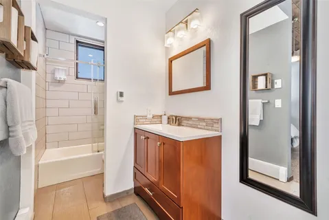 a bathroom with a sink a mirror and a bathtub