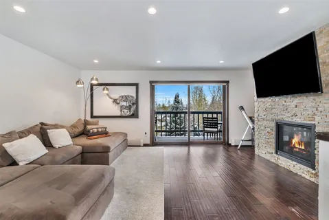 a living room with furniture fireplace and flat screen tv