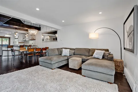 a living room with furniture and kitchen view