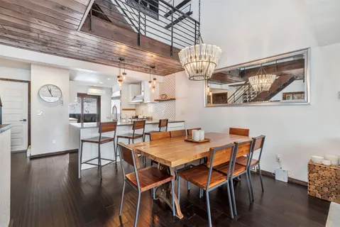 a view of a dining room with furniture wooden floor and chandelier