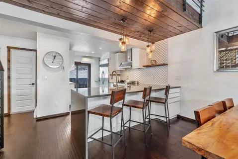 a dining room with furniture and wooden floor