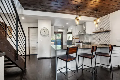 a view of a hallway with seating area and furniture