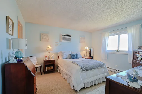 a bedroom with a bed and a lamp