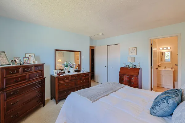 a bedroom with a bed and dresser