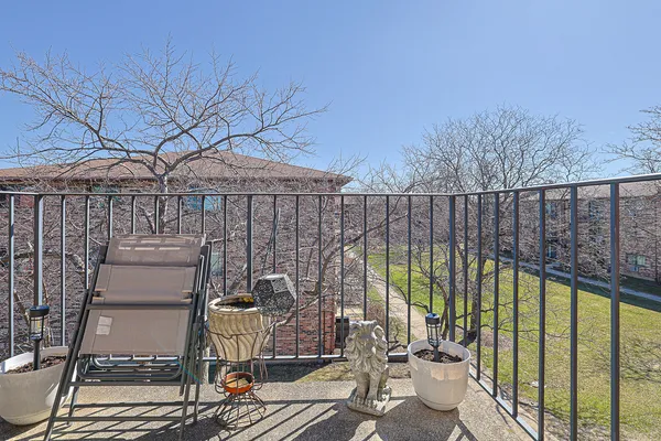 a view of a balcony with two chairs and a table and chair
