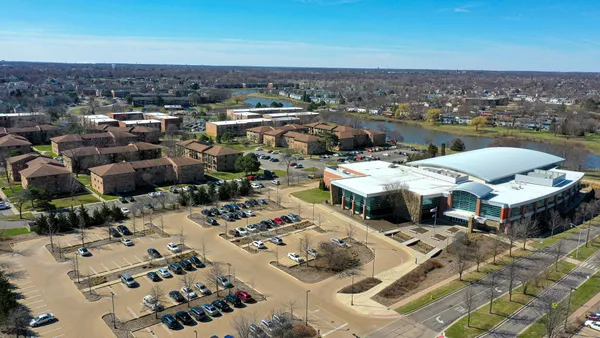 an aerial view of a city with ocean view in back