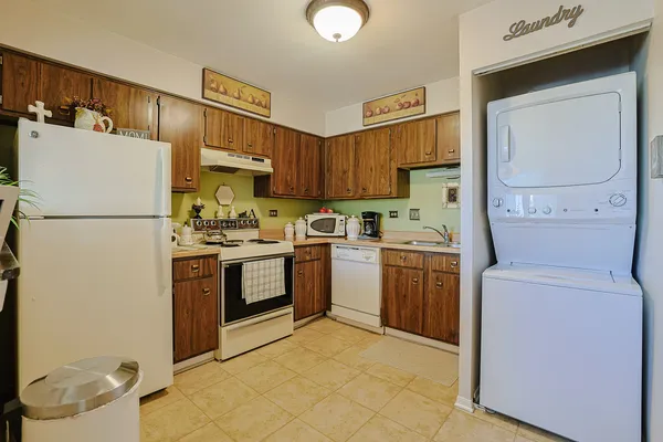 a kitchen with a sink refrigerator and cabinets