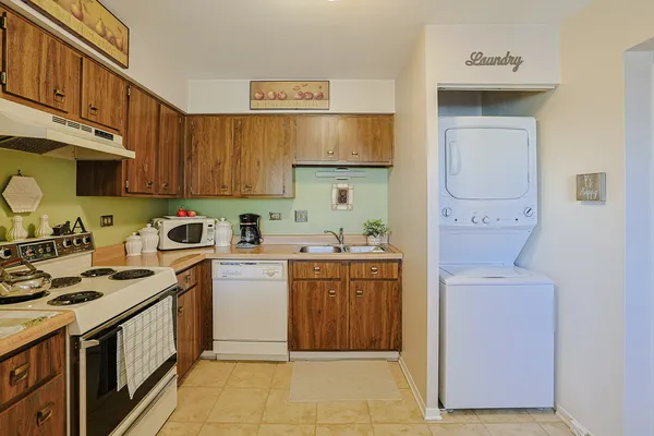 a kitchen with a sink a stove and cabinets