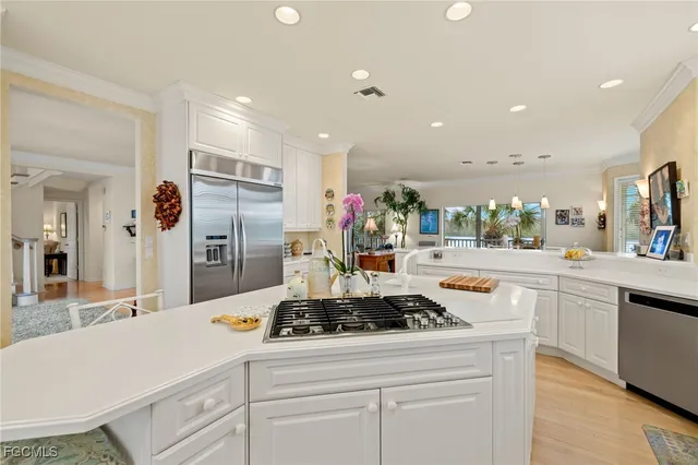 a kitchen with stainless steel appliances kitchen island granite countertop a sink and cabinets
