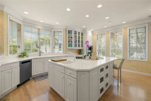 a kitchen with sink stove and cabinets
