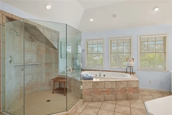 a spacious bathroom with a tub shower and sink