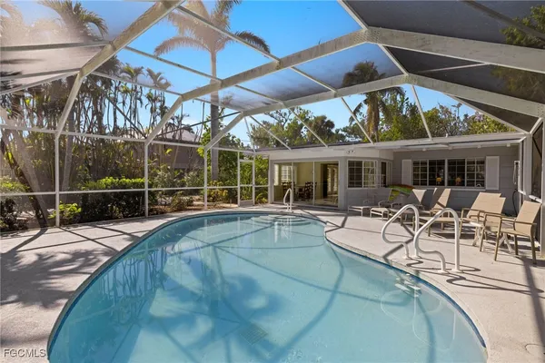 a view of a backyard with sitting area