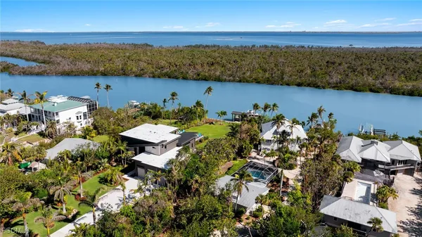 an aerial view of ocean with residential house with outdoor space