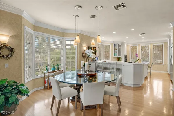 a dining room with furniture window and wooden floor