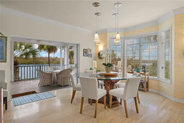a dining room with furniture a chandelier and wooden floor