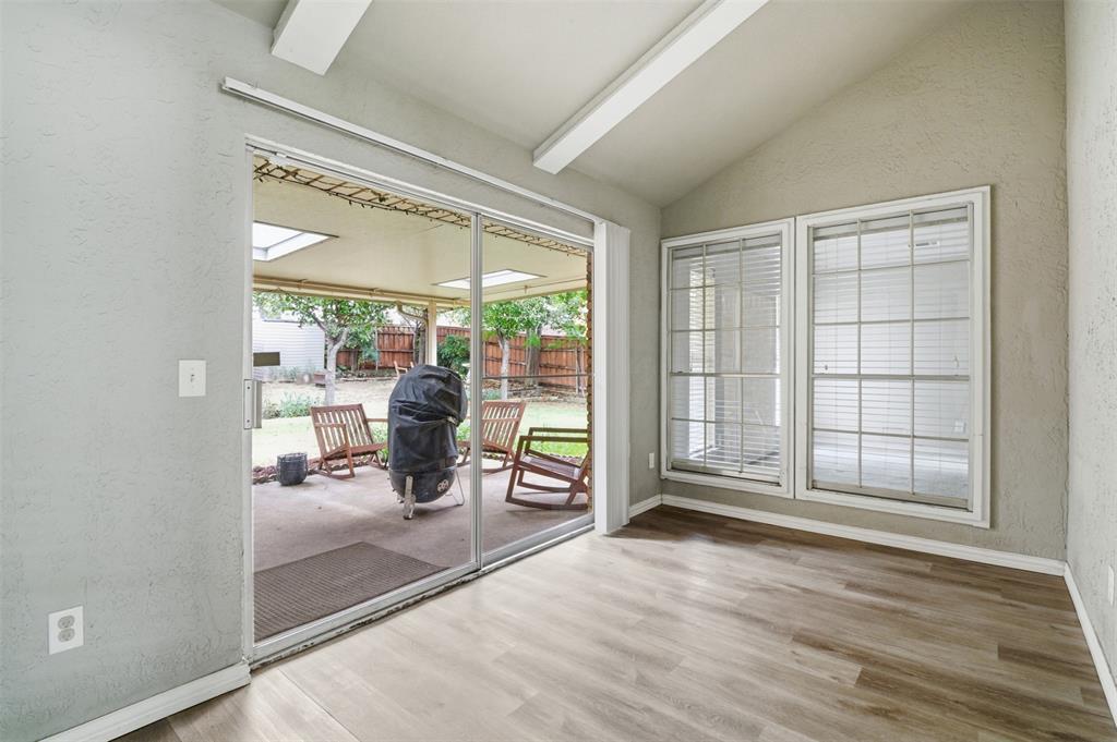 3712 Cemetery Hill Road Carrollton, TX 75007 - Photo 13 of 25 an empty room with wooden floor and floor to ceiling window