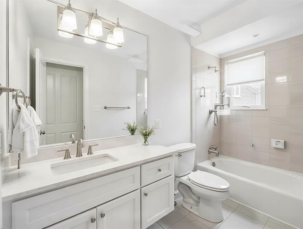 3712 Cemetery Hill Road Carrollton, TX 75007 - Photo 19 of 25 a bathroom with a toilet a sink a tub and a mirror