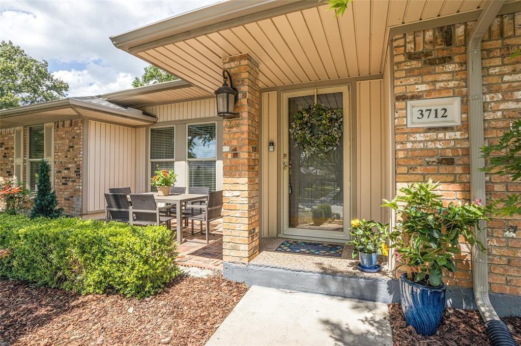 3712 Cemetery Hill Road Carrollton, TX 75007 - Photo 2 of 25 a front view of a house with outdoor seating and plants