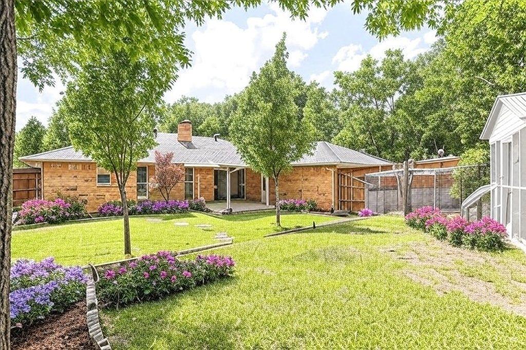 3712 Cemetery Hill Road Carrollton, TX 75007 - Photo 25 of 25 a front view of a house with garden