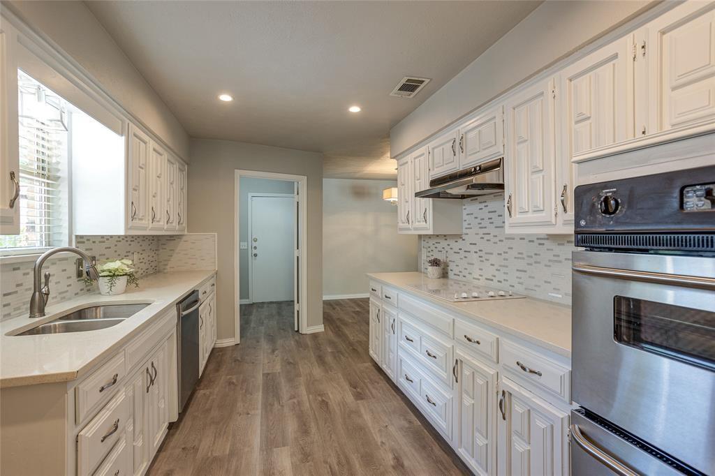 3712 Cemetery Hill Road Carrollton, TX 75007 - Photo 6 of 25 a kitchen with stainless steel appliances sink stove microwave and cabinets
