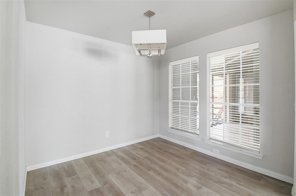 3712 Cemetery Hill Road Carrollton, TX 75007 - Photo 8 of 25 a view of an empty room with wooden floor and a window