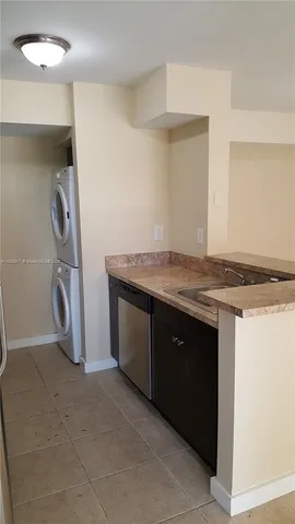 a kitchen with a sink and a refrigerator
