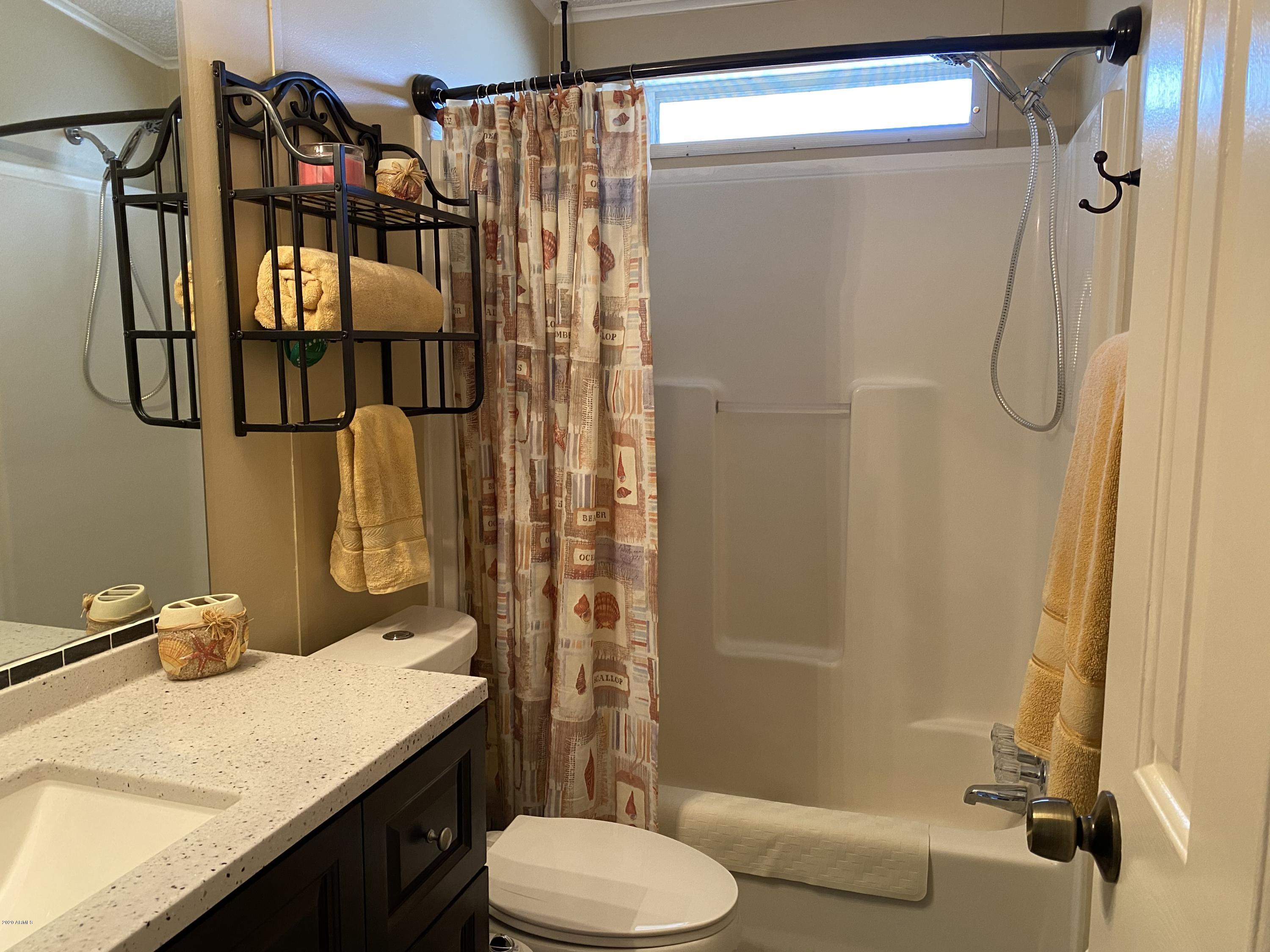 202 North Hawes Road Mesa, AZ 85207 - Photo 12 of 27 a bathroom with a sink toilet and shower