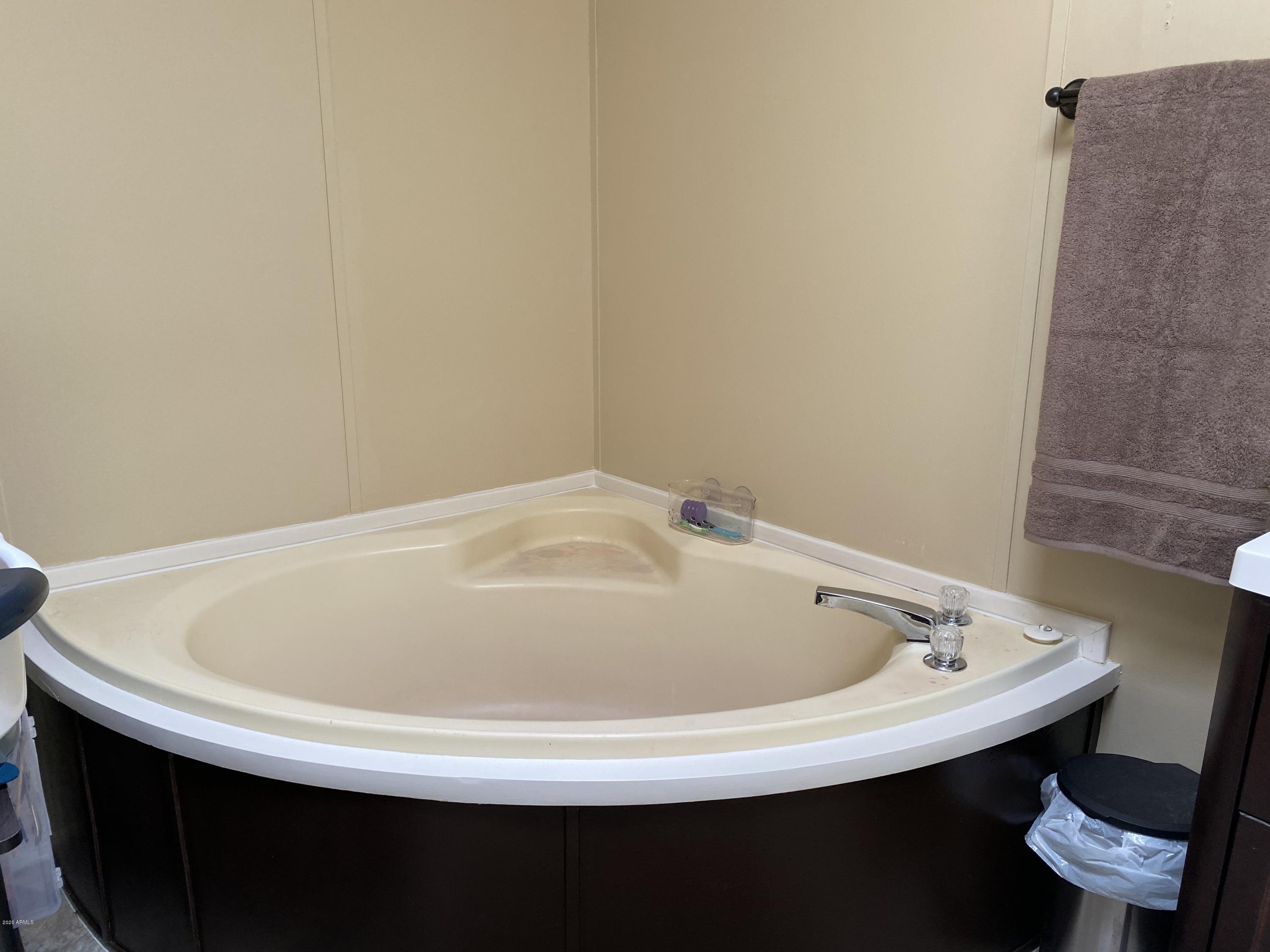 202 North Hawes Road Mesa, AZ 85207 - Photo 16 of 27 a white bath tub sitting in a bathroom