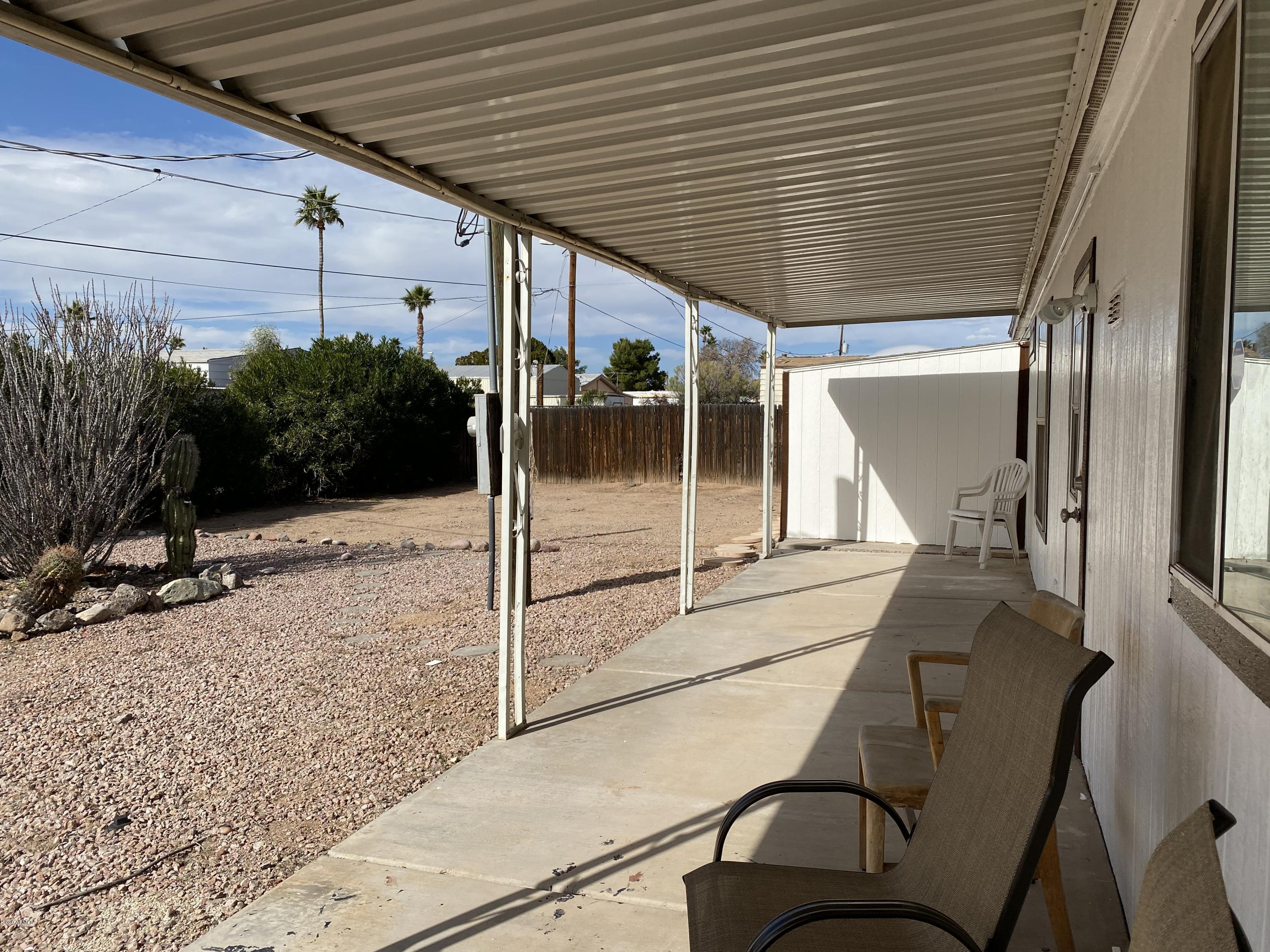 202 North Hawes Road Mesa, AZ 85207 - Photo 22 of 27 a patio with table and chairs with potted plants