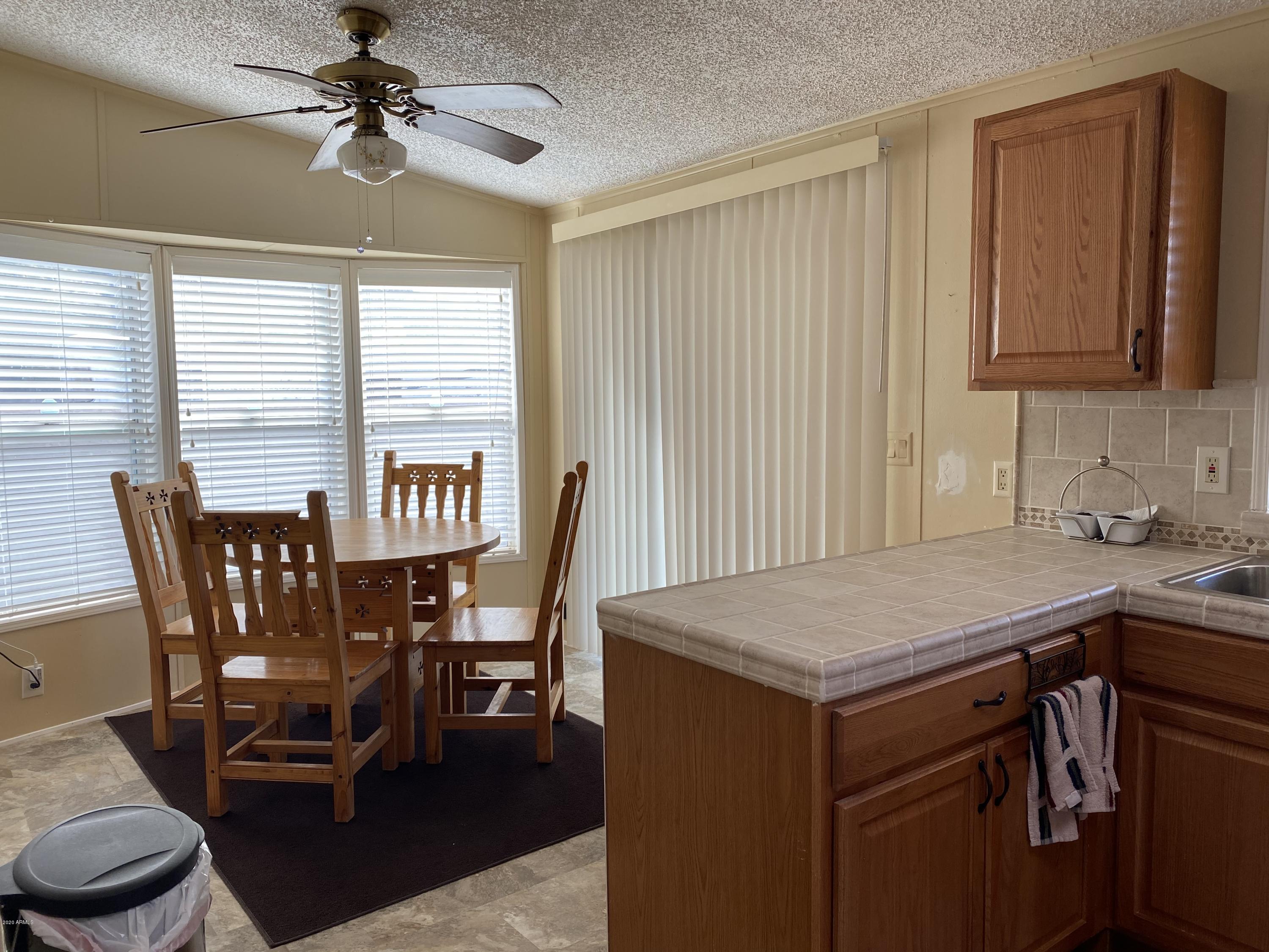 202 North Hawes Road Mesa, AZ 85207 - Photo 7 of 27 a view of a dining room with furniture and a chandelier fan