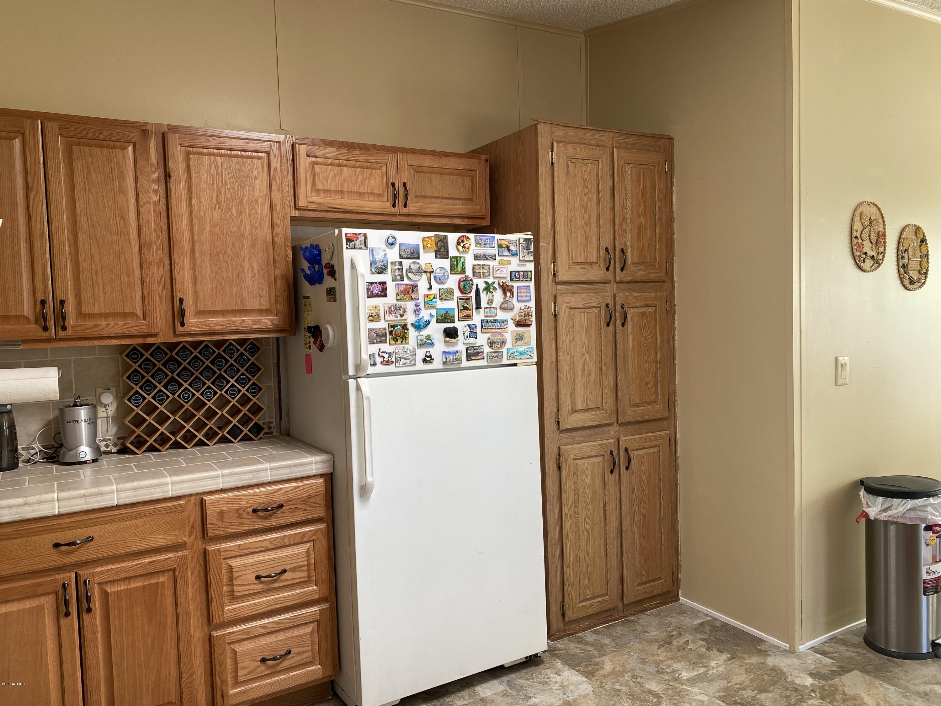 202 North Hawes Road Mesa, AZ 85207 - Photo 10 of 27 a white refrigerator freezer sitting in a kitchen
