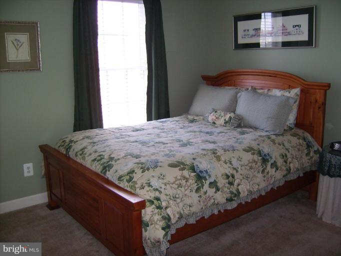 848 West Glebe Road Alexandria, VA 22305 - Photo 11 of 18 a bed sitting in a bedroom next to a window