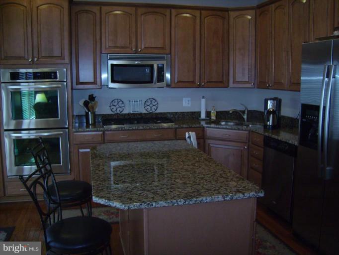 848 West Glebe Road Alexandria, VA 22305 - Photo 7 of 18 a kitchen with granite countertop a stove a microwave a sink and cabinets