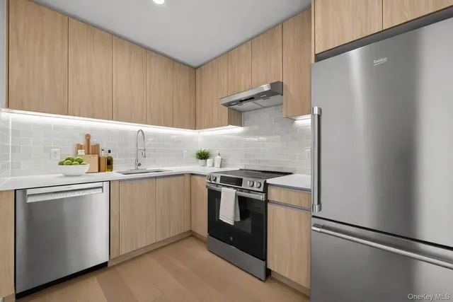 a kitchen with stainless steel appliances a refrigerator and a sink