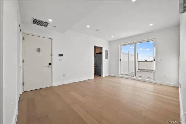 a living room with furniture a mirror and a flat screen tv