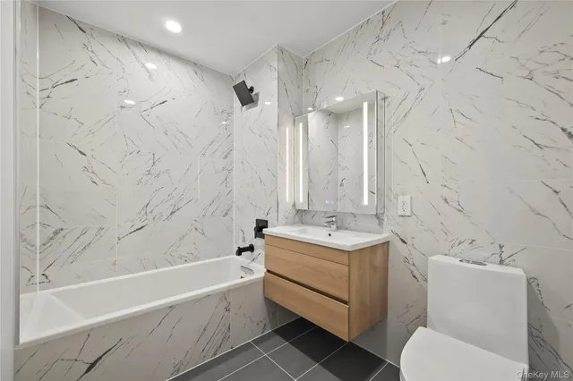 a spacious bedroom with a large bed mirror and a window