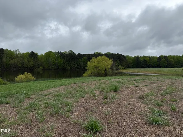 a view of a field with wooden fence