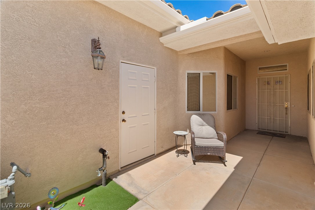 3376 Partridge Run Street Laughlin, NV 89029 - Photo 5 of 92 A welcoming covered patio entrance provides sheltered outdoor leisure space.