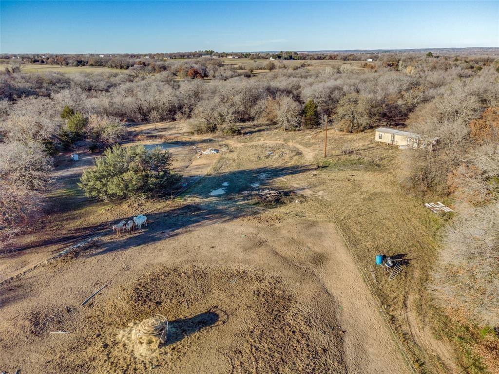 319 County Road 4868 Azle, TX 76020 - Photo 3 of 22 Arial view of the property. Grazing Pasture is in front with the wooded 2 acres towards the back of the image.