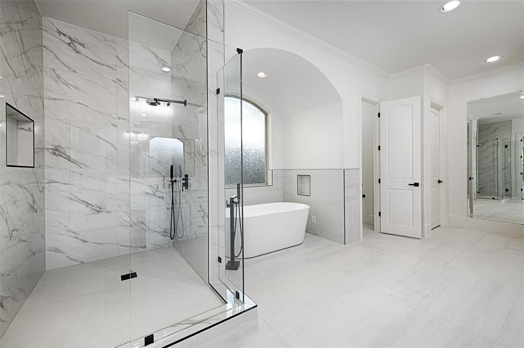 6301 Churchill Way Dallas, TX 75230 - Photo 22 of 40 Bathroom featuring a freestanding tub, a marble finish shower, recessed lighting, and ornamental molding