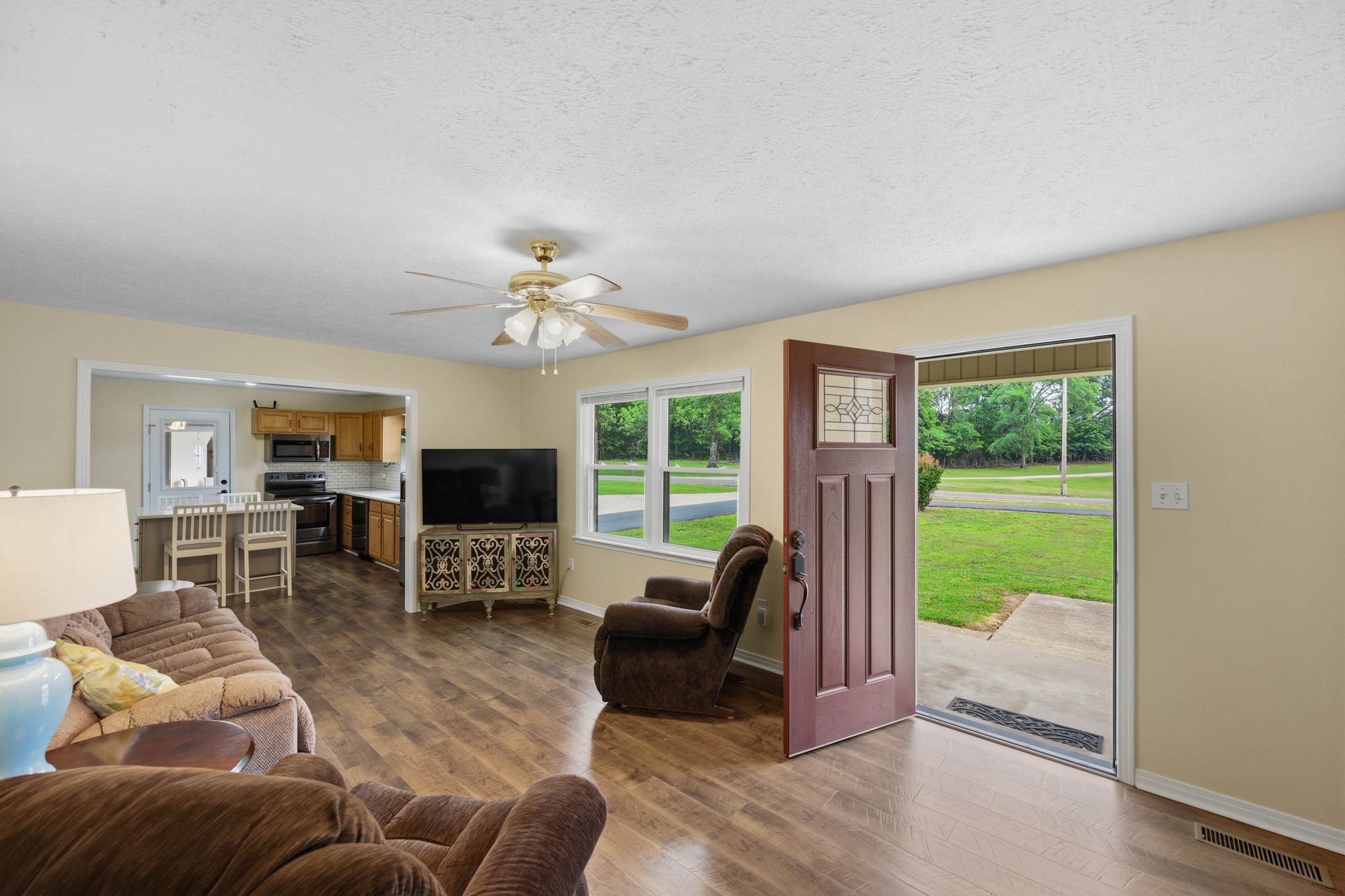 944 Brooksie Thompson Road Decaturville, TN 38329 - Photo 6 of 47 a living room with furniture a fireplace and a flat screen tv