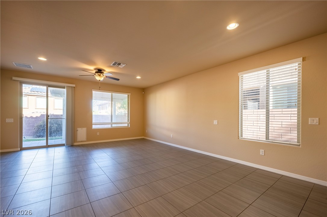 11016 Prairie Grove Road Las Vegas, NV 89179 - Photo 12 of 37 An inviting open-concept area featuring modern tile flooring and recessed lighting.