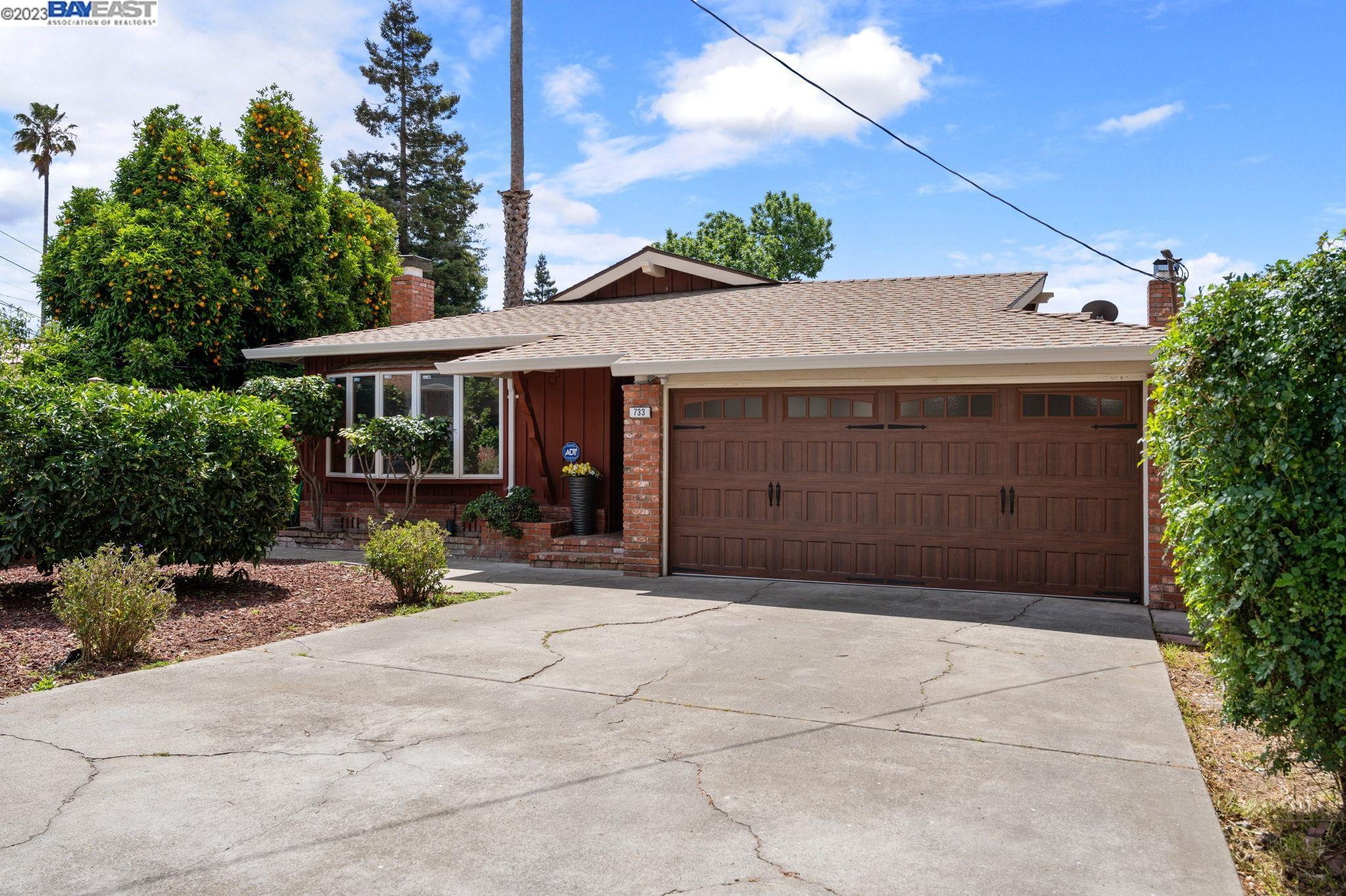 a front view of a house with a garden
