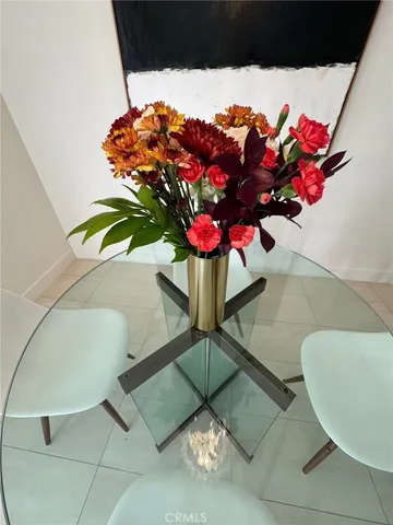 a vase of flowers sitting on a floor