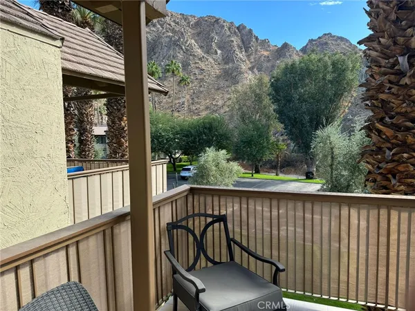 a view of a chair and table in the balcony