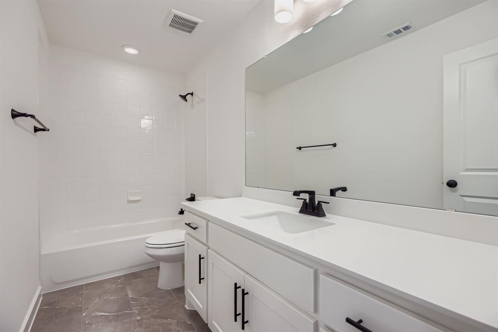 2608 Cedar Rdg Road Celina, TX 75009 - Photo 22 of 29 a bathroom with a sink a toilet and shower