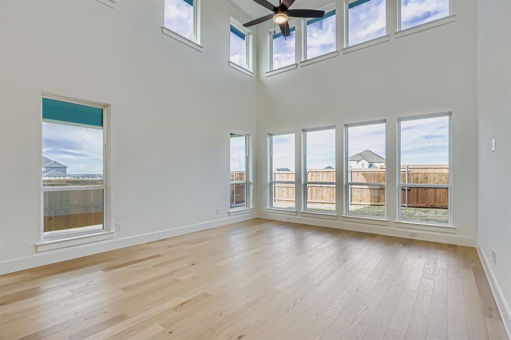2608 Cedar Rdg Road Celina, TX 75009 - Photo 5 of 29 a view of an empty room with wooden floor and a window